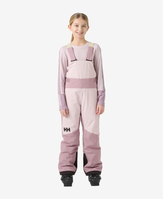 Image of a model wearing Pants. Product name - JR GIRL STELLAR BIB PANT, Purple Clay in Purple Clay colour by brand - Helly Hansen