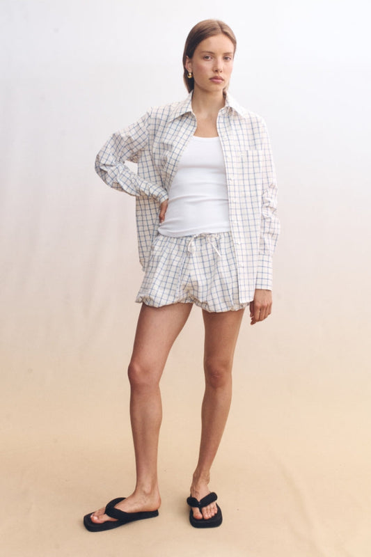 Image of a model wearing Shorts. Product name - Isley Shorts White in White colour by brand - Blanca Studio