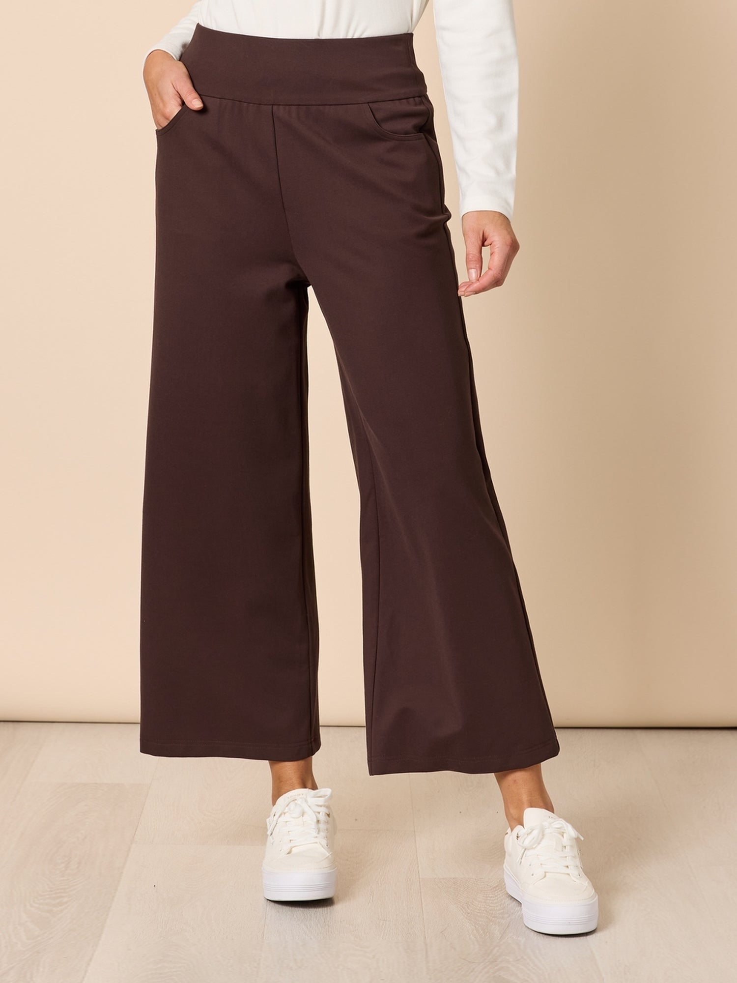 Image of a model wearing Pants. Product name - Kimmy Ponti Wide Leg Pant Coffee in Coffee colour by brand - Clarity