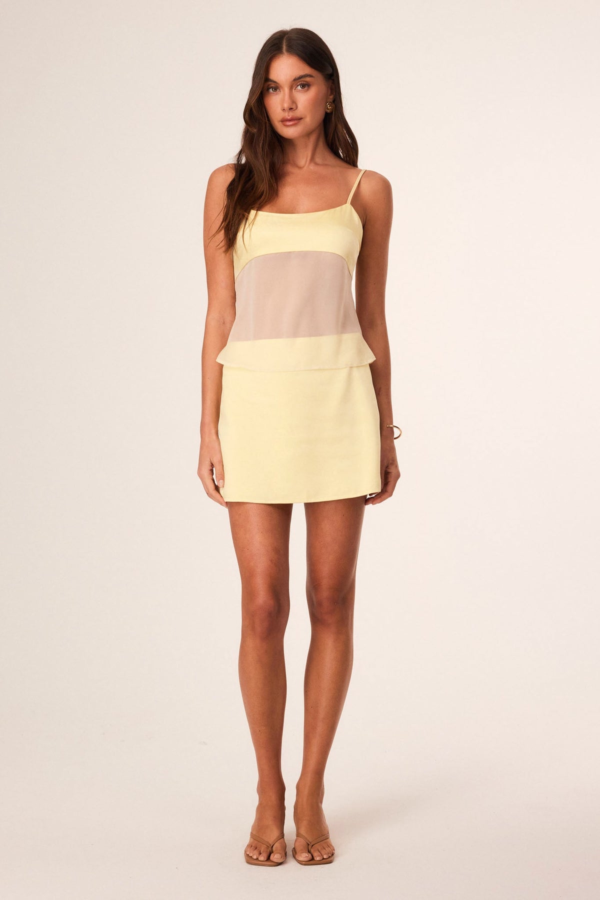 Image of a model wearing Skirts. Productname: SNDYS ZOE MINI SKIRT in Butter colour by brand - SNDYS