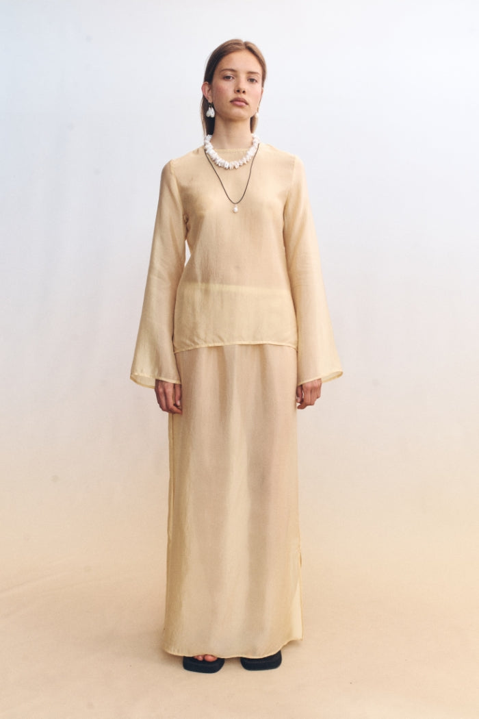 Image of a model wearing Tops. Product name - Nerina Top Butter in Butter colour by brand - Blanca Studio