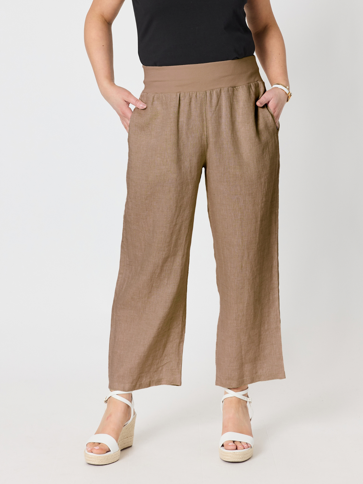 Image of a model wearing Pants. Product name - Lara Wide Leg Linen Pant Mocha in Mocha colour by brand - Gordon Smith