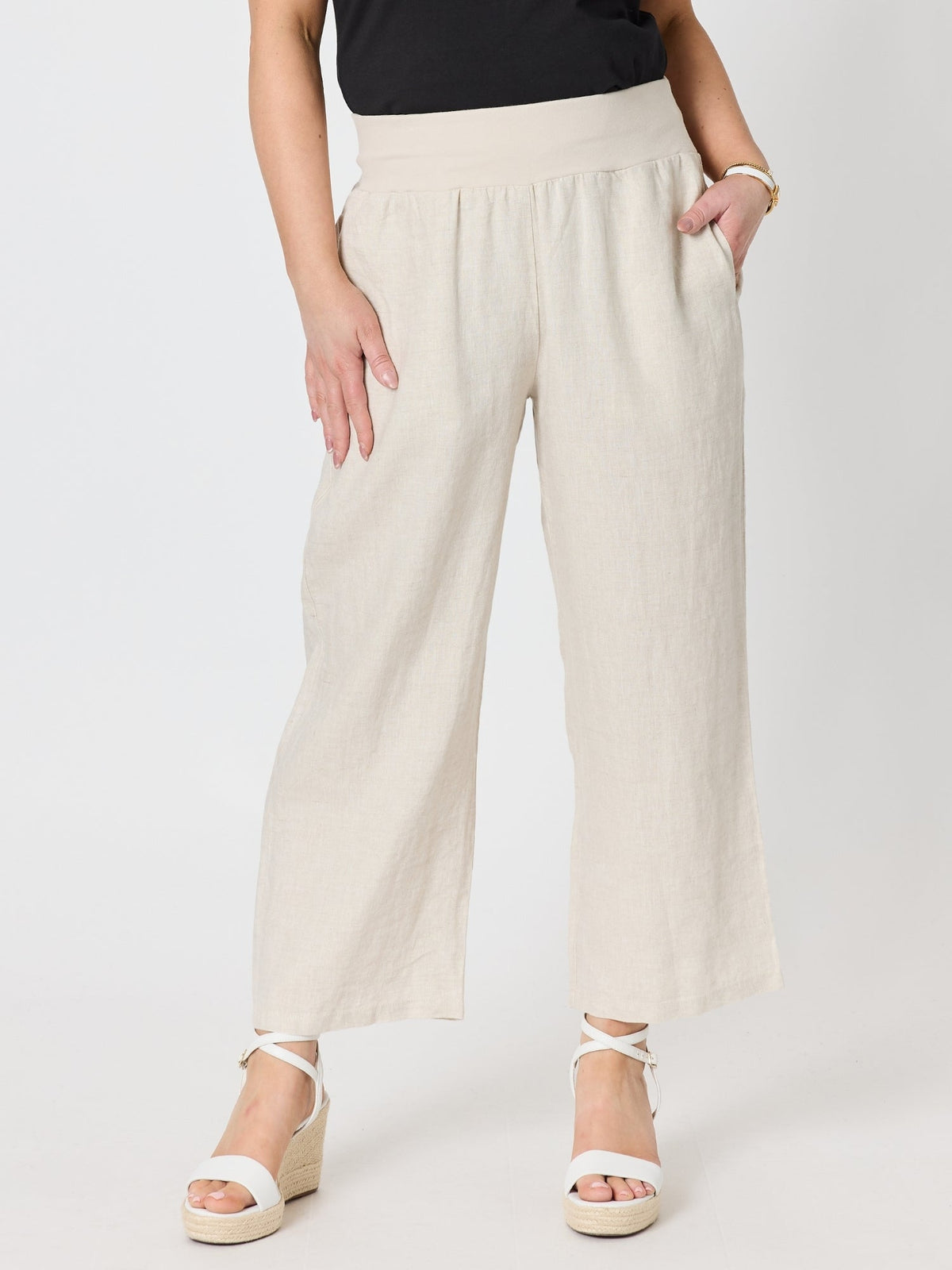 Image of a model wearing Pants. Product name - Lara Wide Leg Linen Pant Natural in Natural colour by brand - Gordon Smith
