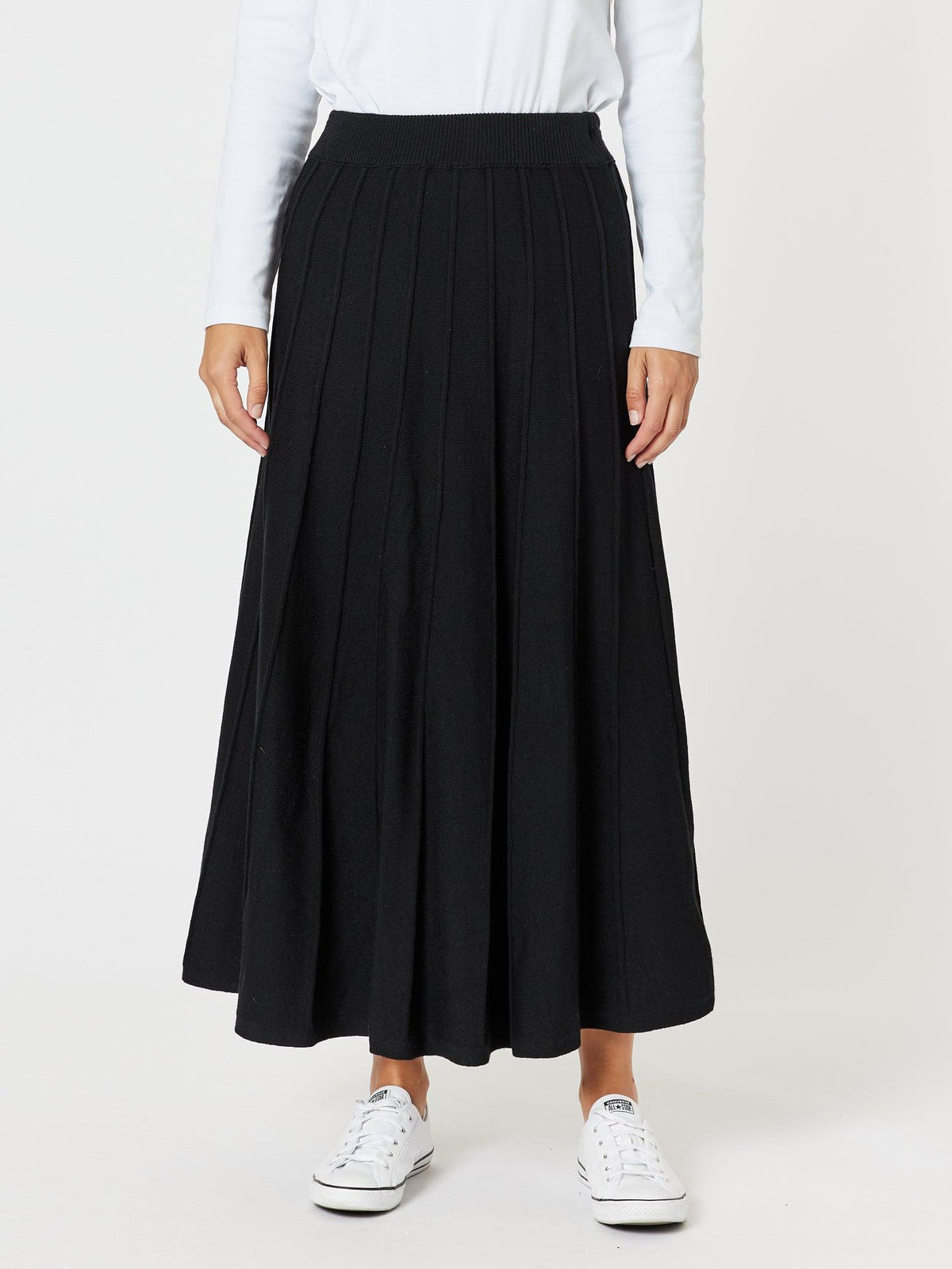 Image of a model wearing Skirts. Product name - Kate Long Knit Skirt Black in Black colour by brand - Gordon Smith