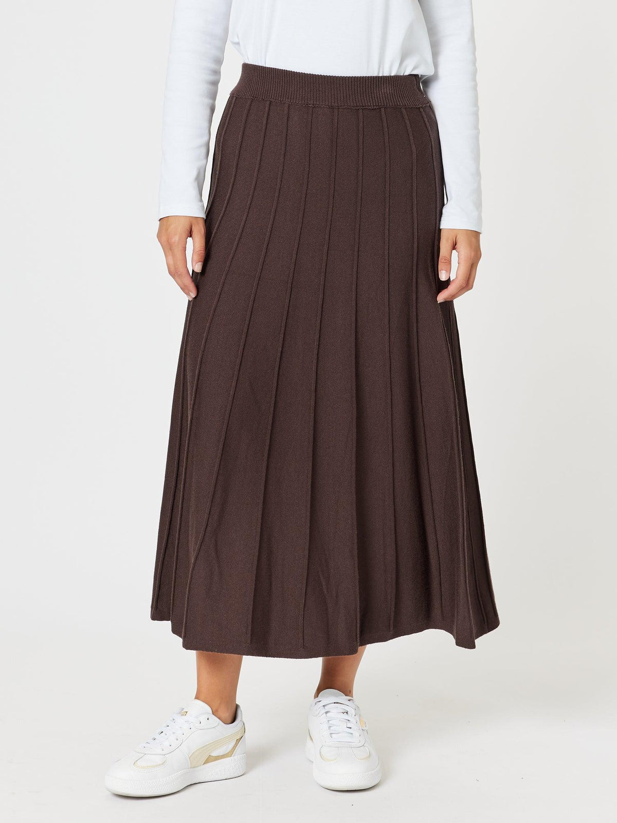 Image of a model wearing Skirts. Product name - Kate Long Knit Skirt Chocolate in Chocolate colour by brand - Gordon Smith