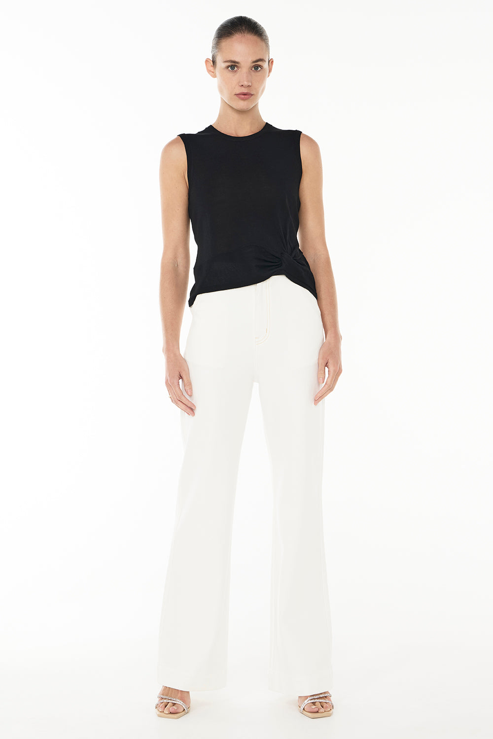 Image of a model wearing Tops. Productname: Twisted Knit Top in BLACK colour by brand - Manning Cartell