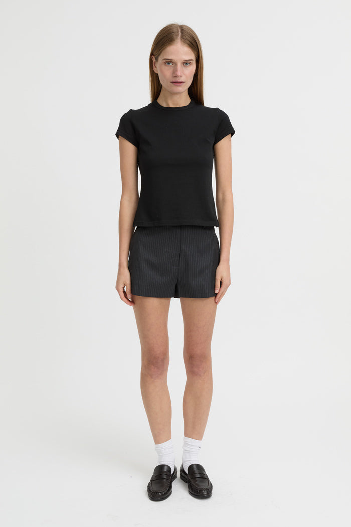 Image of a model wearing Shorts. Product name - Bean Shorts Charcoal in Charcoal colour by brand - Blanca Studio