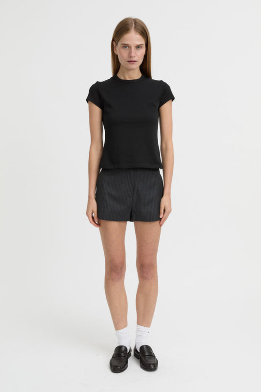 Image of a model wearing Shorts. Product name - Bean Shorts Charcoal in Charcoal colour by brand - Blanca Studio