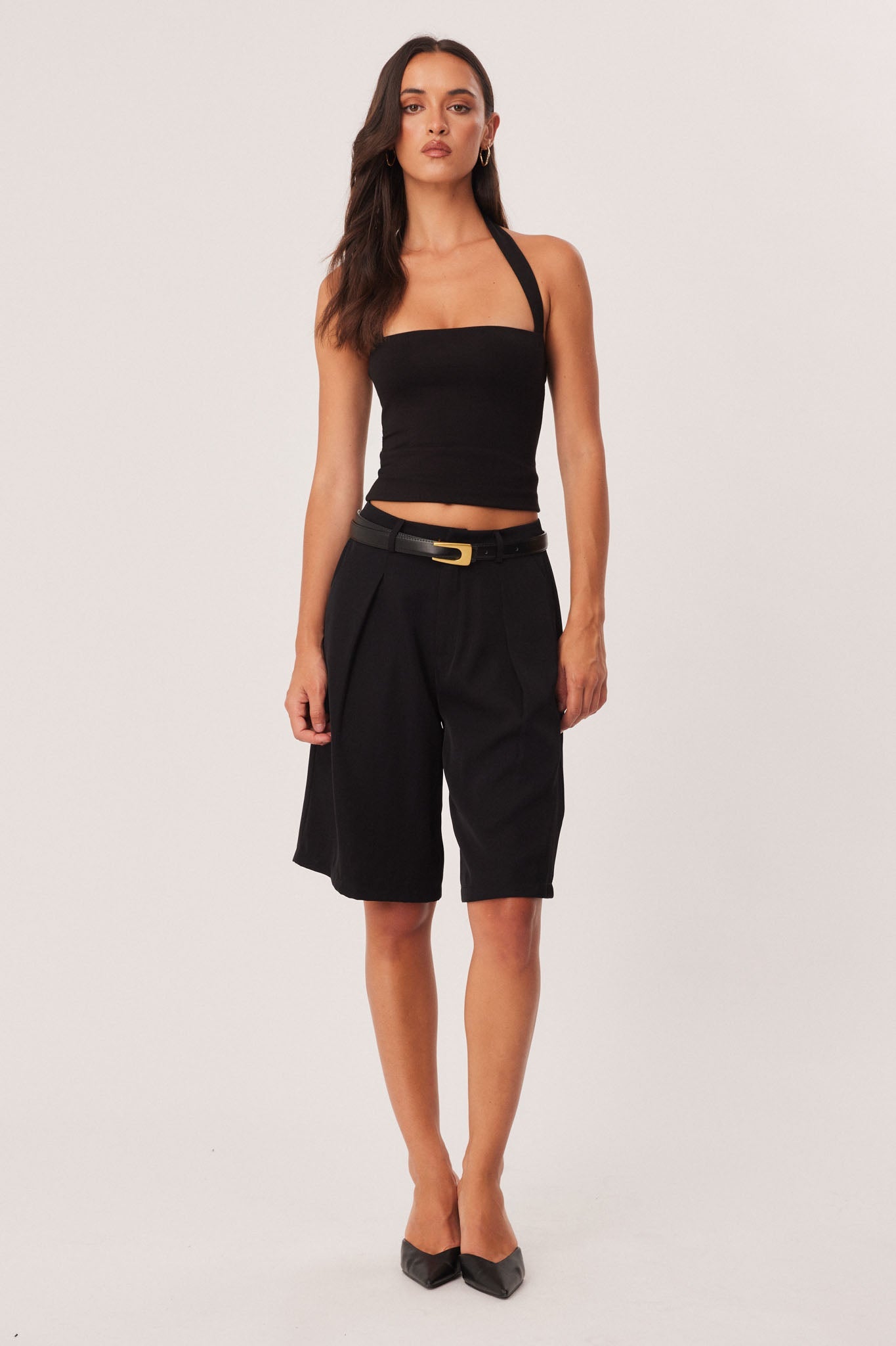 Image of a model wearing Shorts. Productname: SNDYS REECE BERMUDA SHORTS in Black colour by brand - SNDYS