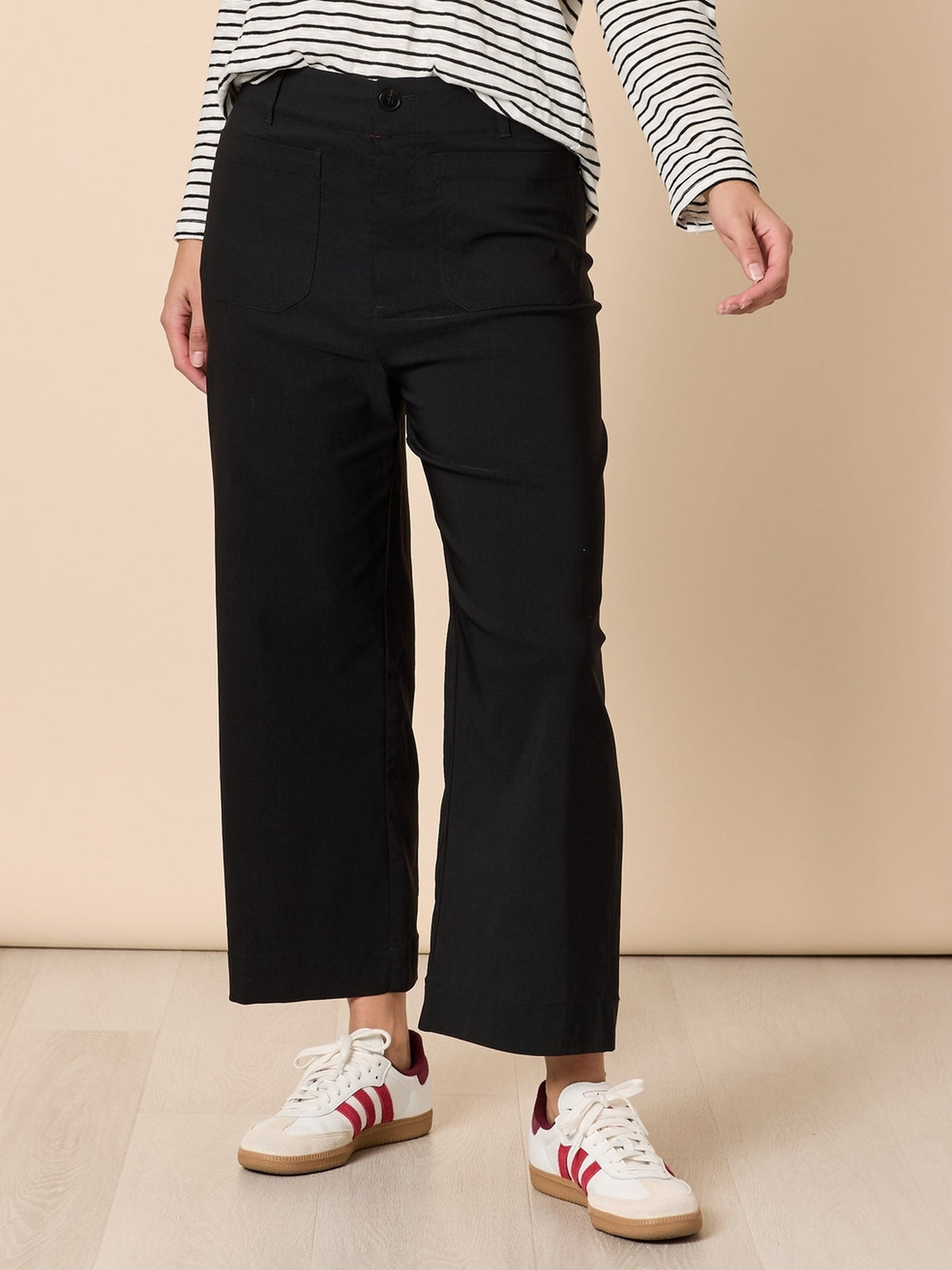 Image of a model wearing Pants. Product name - Marine Wide Leg Pant Black in Black colour by brand - Threadz