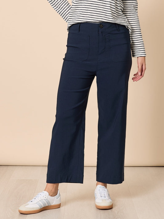 Image of a model wearing Pants. Product name - Marine Wide Leg Pant Navy in Navy colour by brand - Threadz