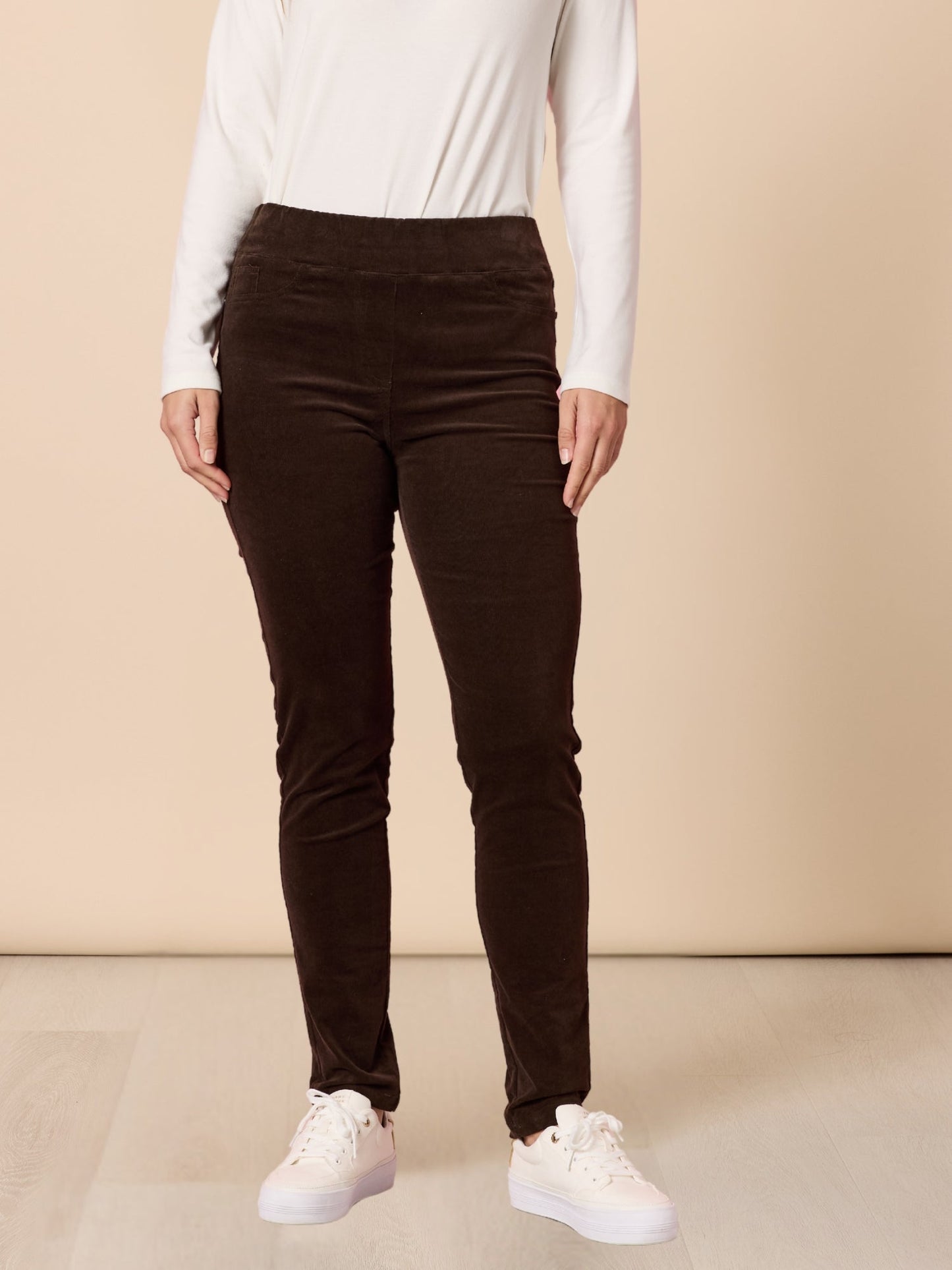 Image of a model wearing Pants. Product name - Harper Slim Leg Cord Pant Coffee in Coffee colour by brand - Gordon Smith