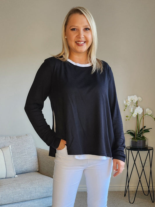 Image of a model wearing Tops. Product name - Alice 2in1 Knit Top Black in Black colour by brand - Threadz