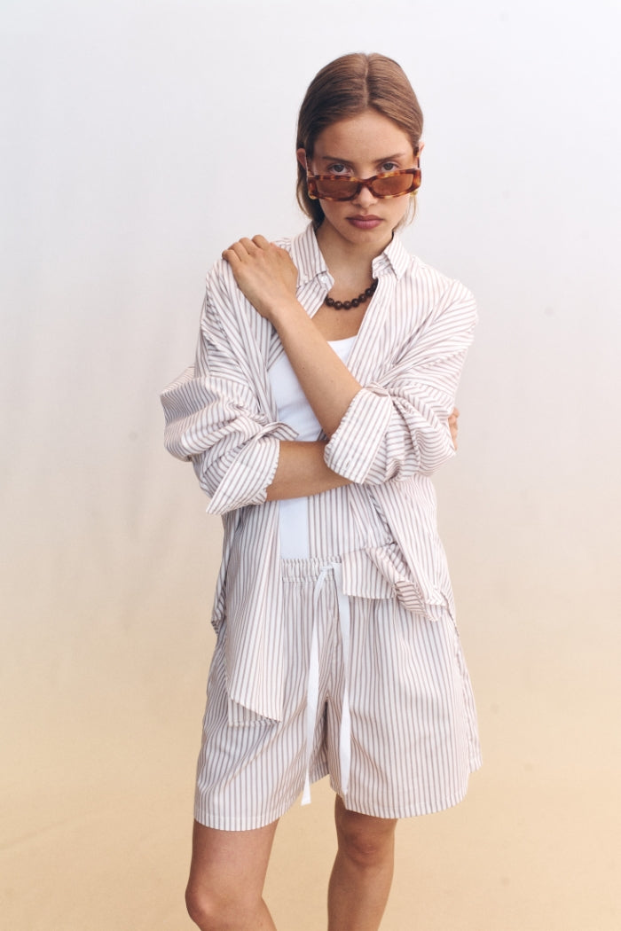 Image of a model wearing Shorts. Product name - Nova Shorts Beige in Beige colour by brand - Blanca Studio