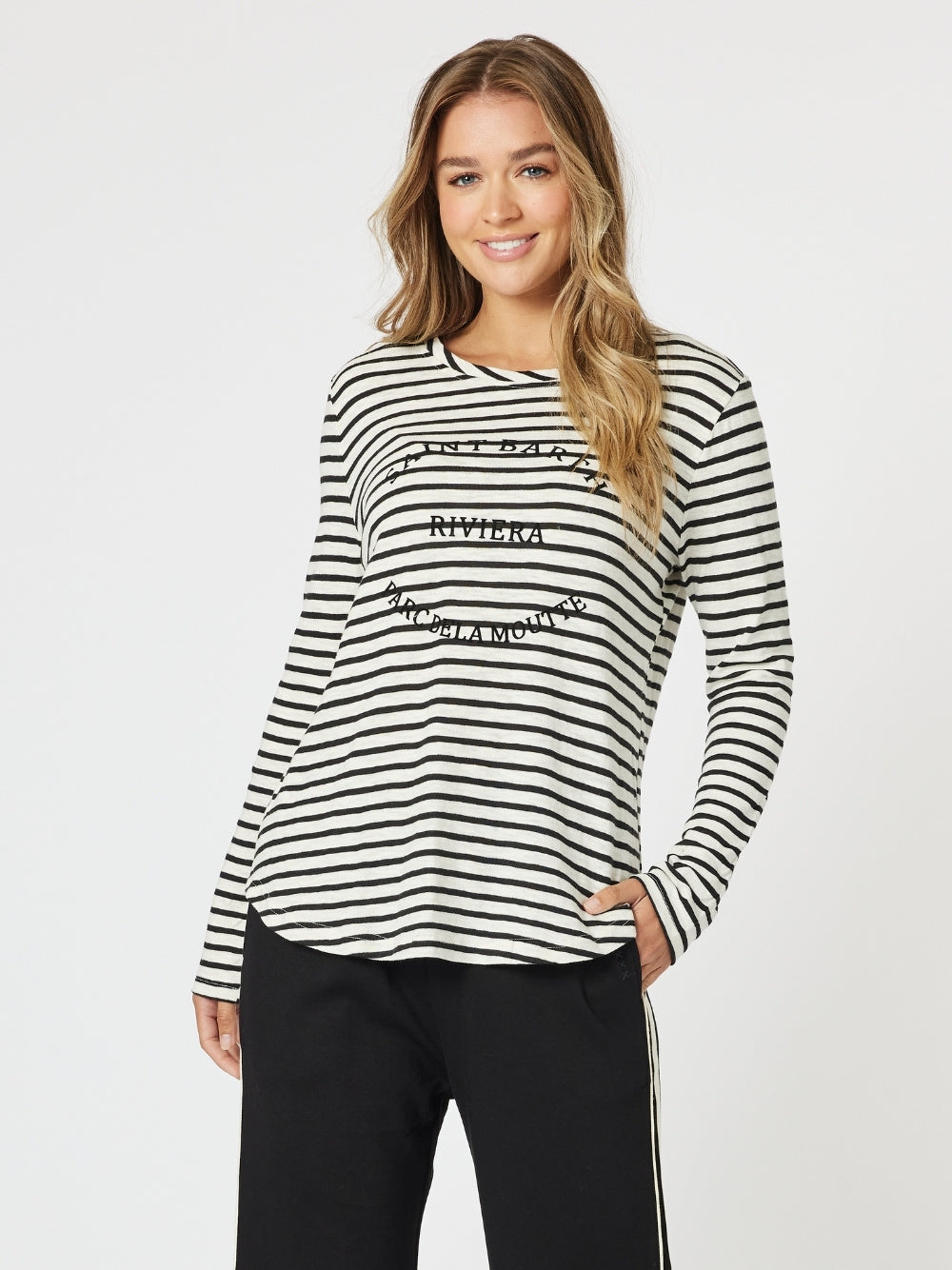 Image of a model wearing Tops. Product name - Riviera Long Sleeve Stripe Print Tee Black/White in Black/White colour by brand - Threadz