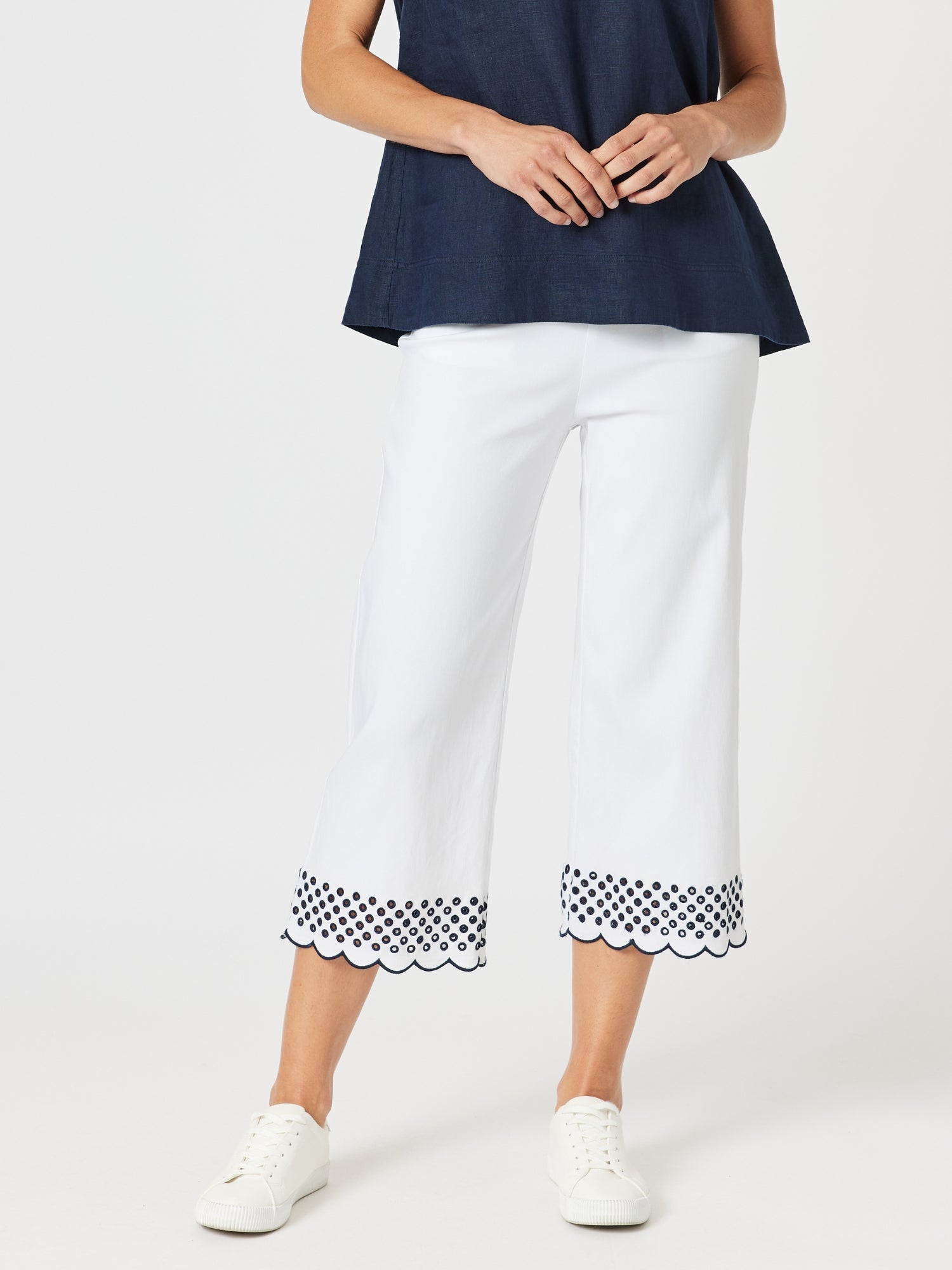 Image of a model wearing Pants. Product name - Scallop Hem Pant White/Navy in White/Navy colour by brand - Gordon Smith