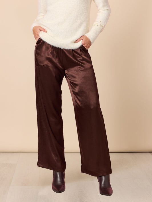 Image of a model wearing Pants. Product name - Opera Pant Espresso in Espresso colour by brand - Hammock & Vine