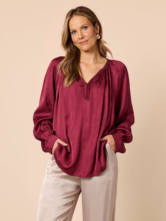 Image of a model wearing Tops. Product name - Lux Plait Top Shiraz in Shiraz colour by brand - Hammock & Vine