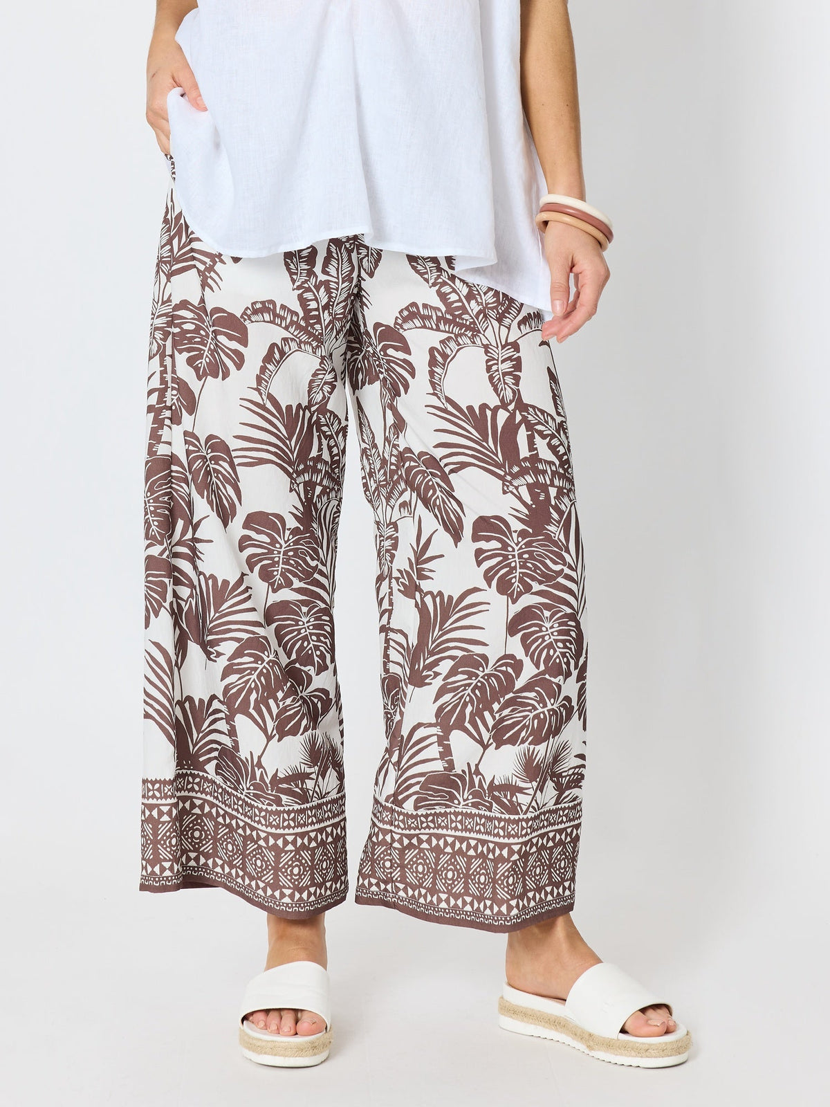 Image of a model wearing Pants. Product name - Palm Cove Print Wide Leg Pant Espresso White in Espresso White colour by brand - Hammock & Vine
