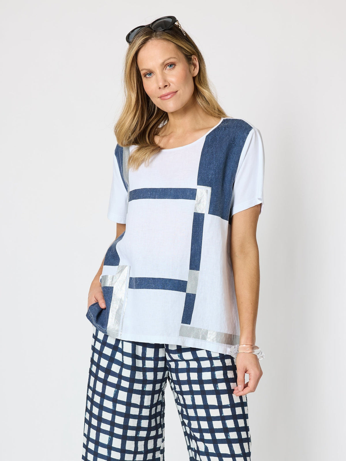 Image of a model wearing Tops. Product name - Geometric Top White/Silver in White/Silver colour by brand - Clarity
