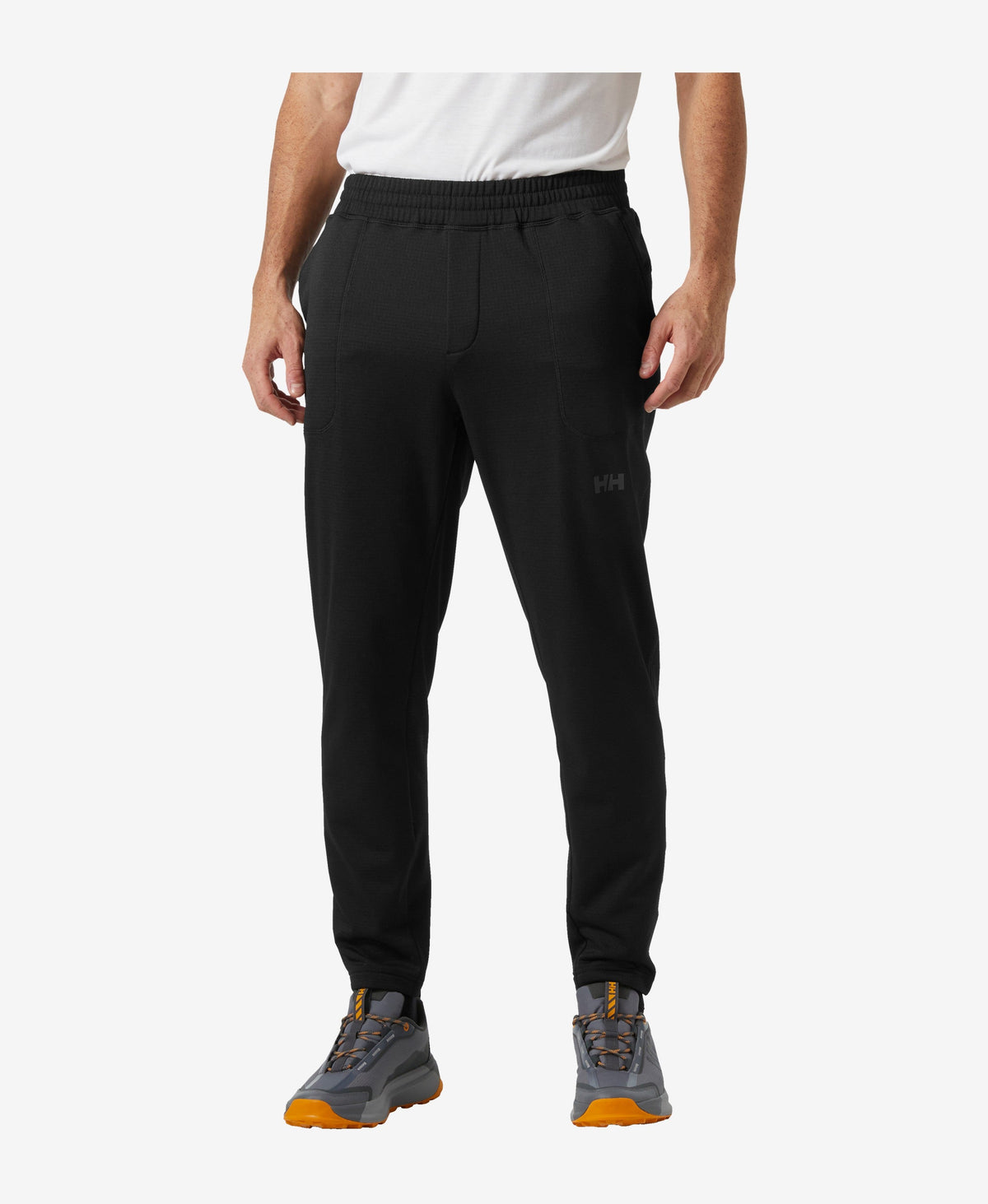 Image of a model wearing Pants. Product name - VERSALITE FLEECE PANT, Black in Black colour by brand - Helly Hansen