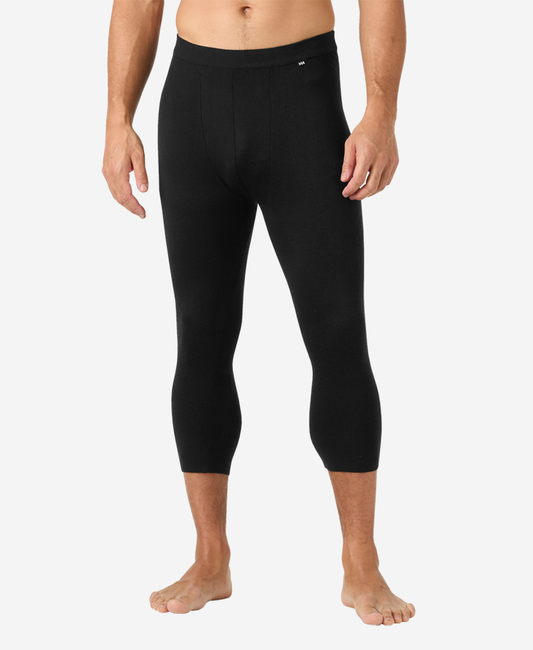 Image of a model wearing Pants. Product name - LIFA MERINO KNITEVO 3/4 PANT, Black in Black colour by brand - Helly Hansen