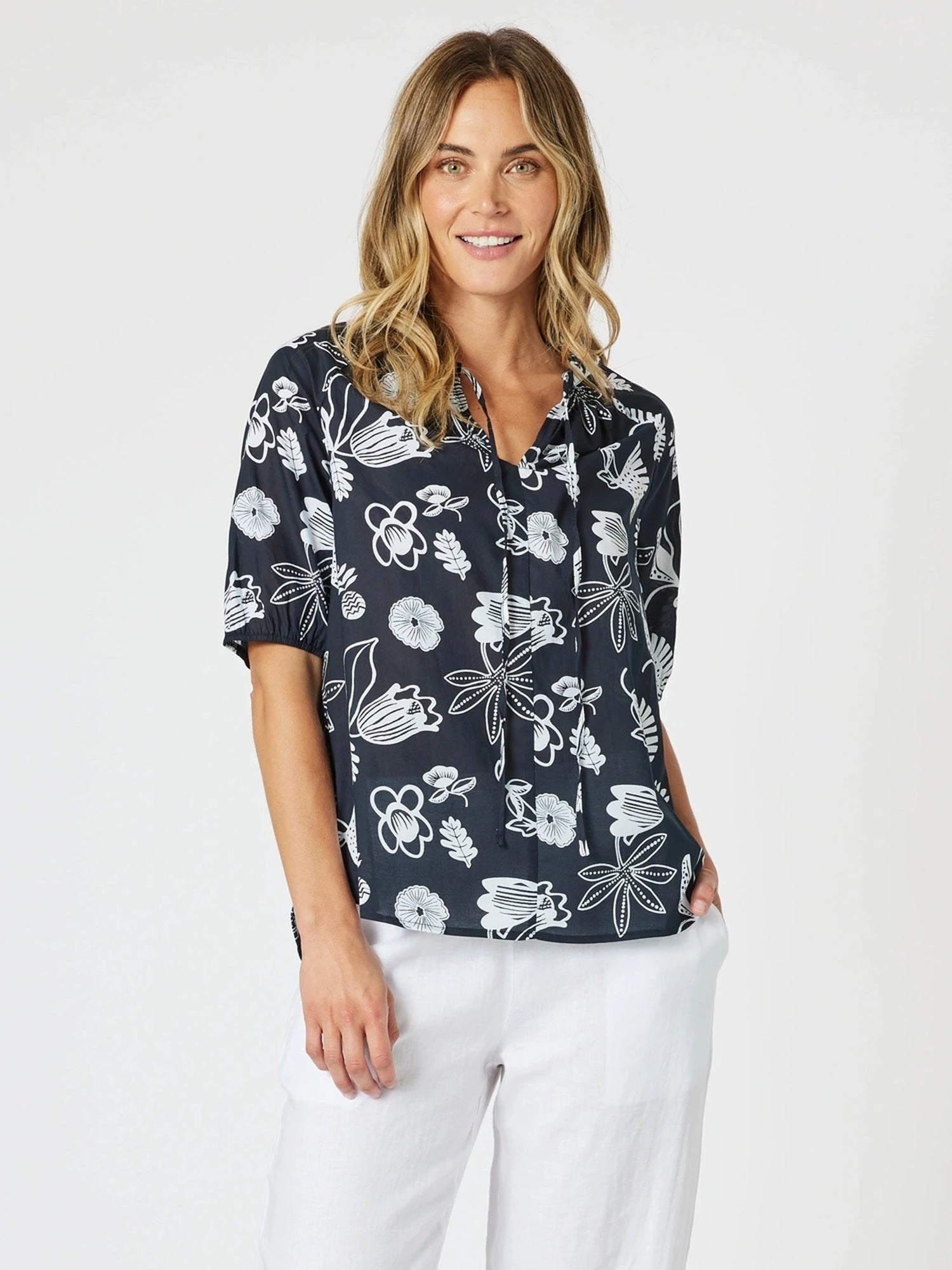 Image of a model wearing Tops. Product name - Palm Springs Top Navy/White in Navy/White colour by brand - Gordon Smith