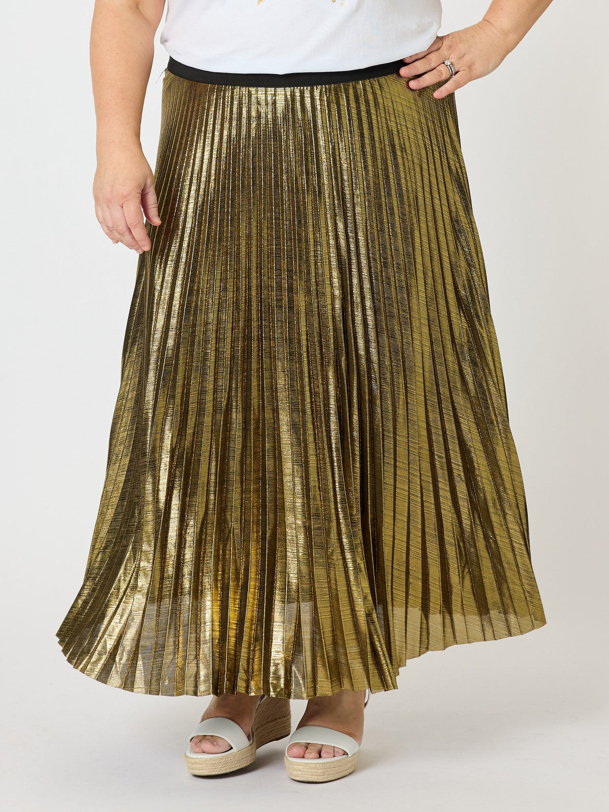 Image of a model wearing Skirts. Product name - Shimmer Pleated Skirt Gold in Gold colour by brand - Threadz