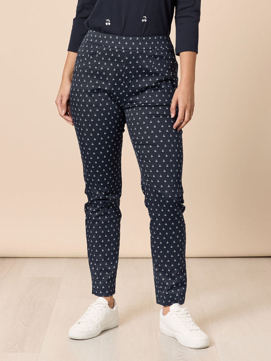 Image of a model wearing Pants. Product name - Cherry Print Slim Leg Pant Navy/White in Navy/White colour by brand - Gordon Smith