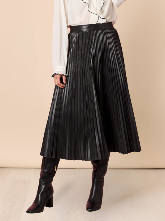 Image of a model wearing Skirts. Product name - Florence Pleat Skirt Black in Black colour by brand - Hammock & Vine
