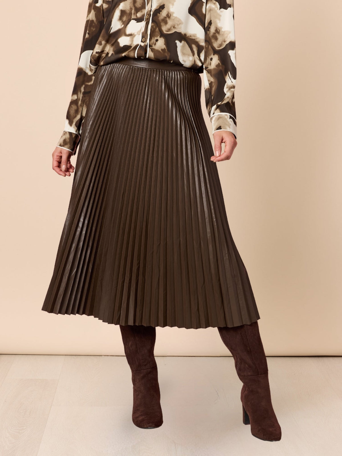 Image of a model wearing Skirts. Product name - Florence Pleat Skirt Espresso in Espresso colour by brand - Hammock & Vine