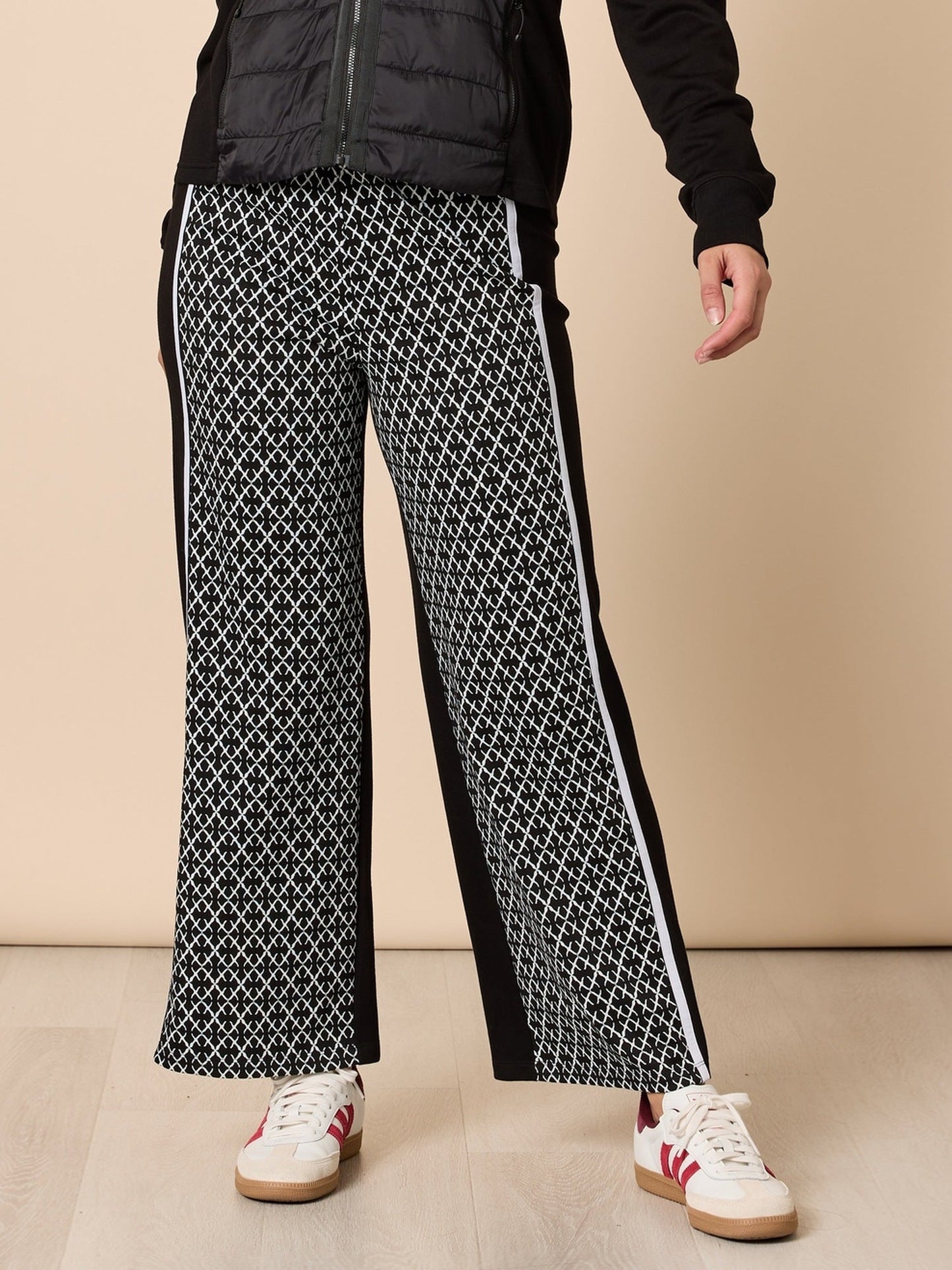 Image of a model wearing Pants. Product name - Empire Spliced Pant Black/Ivory in Black/Ivory colour by brand - Threadz