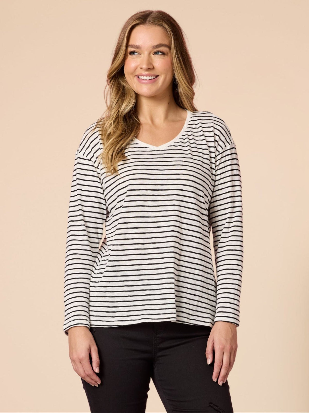 Image of a model wearing Tops. Product name - City Stripe Long Sleeve Tee Black/Ivory in Black/Ivory colour by brand - Threadz