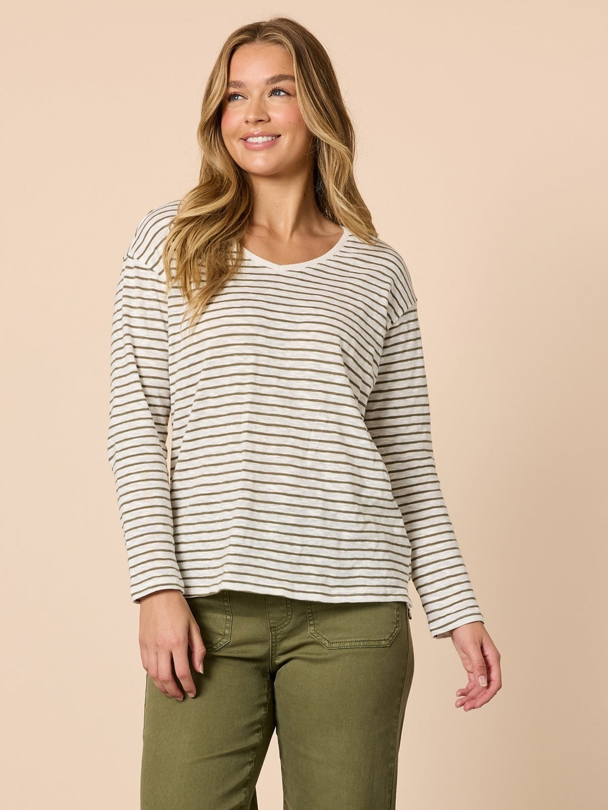 Image of a model wearing Tops. Product name - City Stripe Long Sleeve Tee Khaki Ivory in Khaki Ivory colour by brand - Threadz