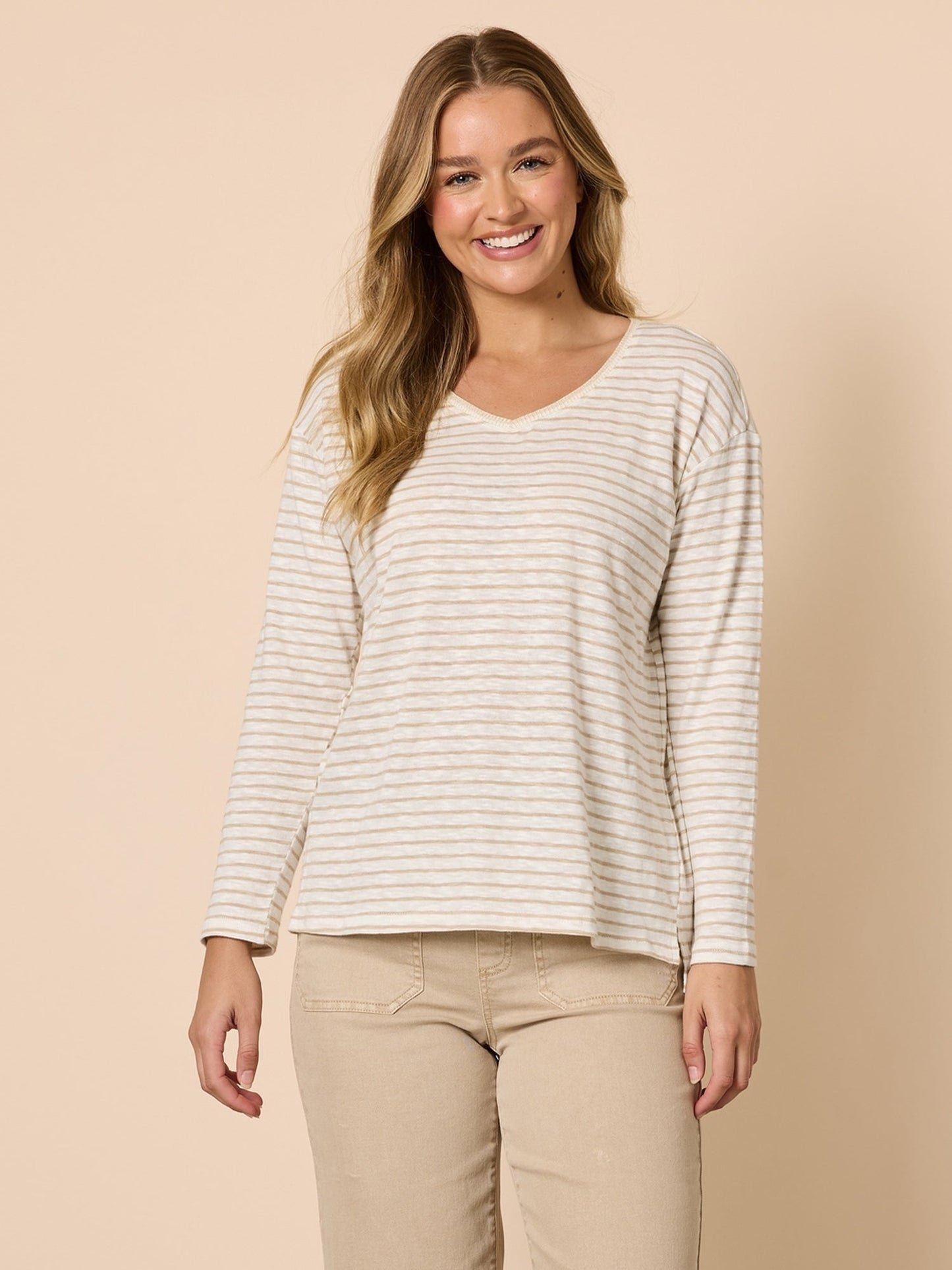 Image of a model wearing Tops. Product name - City Stripe Long Sleeve Tee Natural Ivory in Natural Ivory colour by brand - Threadz