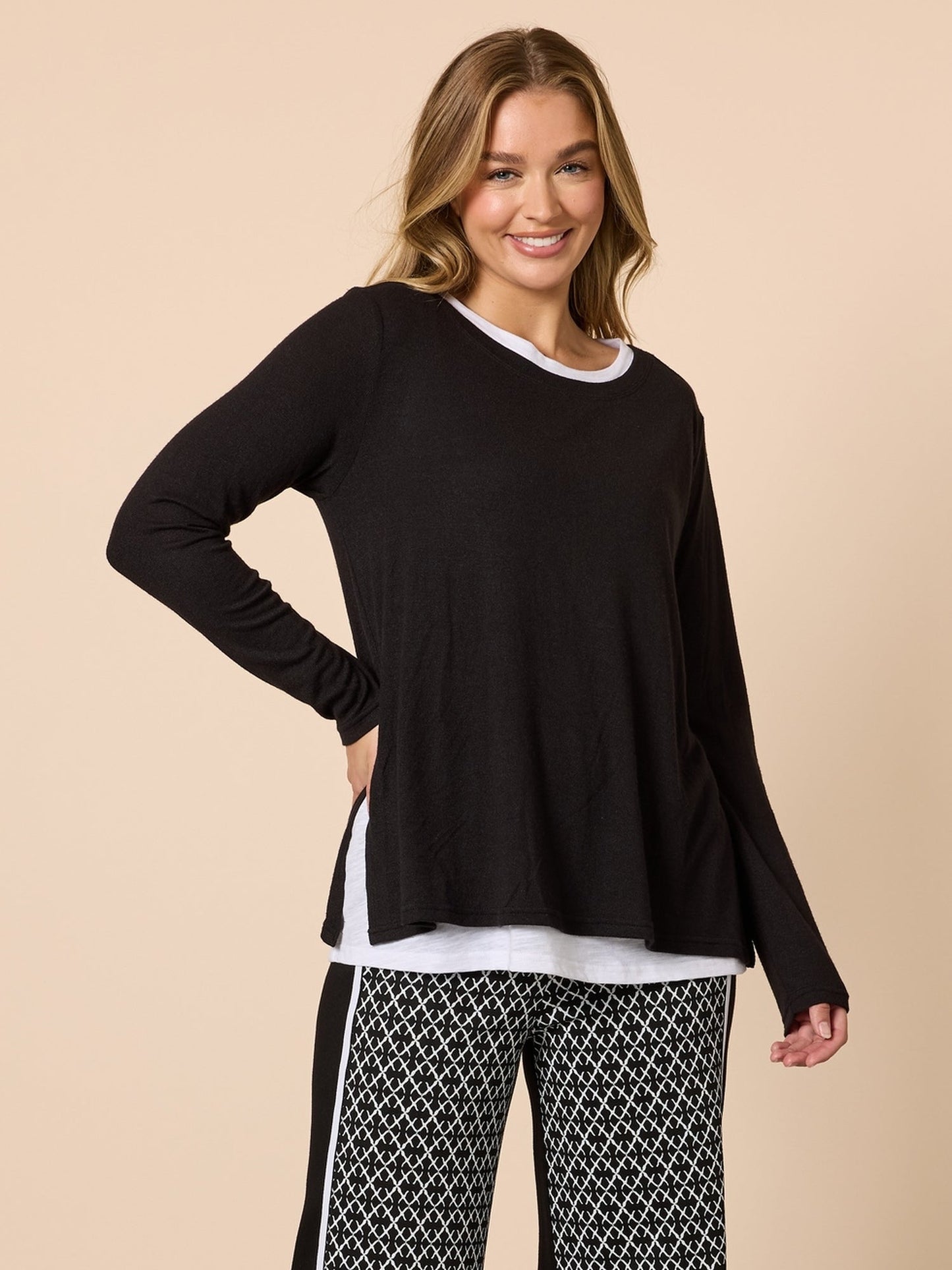 Image of a model wearing Tops. Product name - Alicia 2 in 1 Top Black in Black colour by brand - Threadz