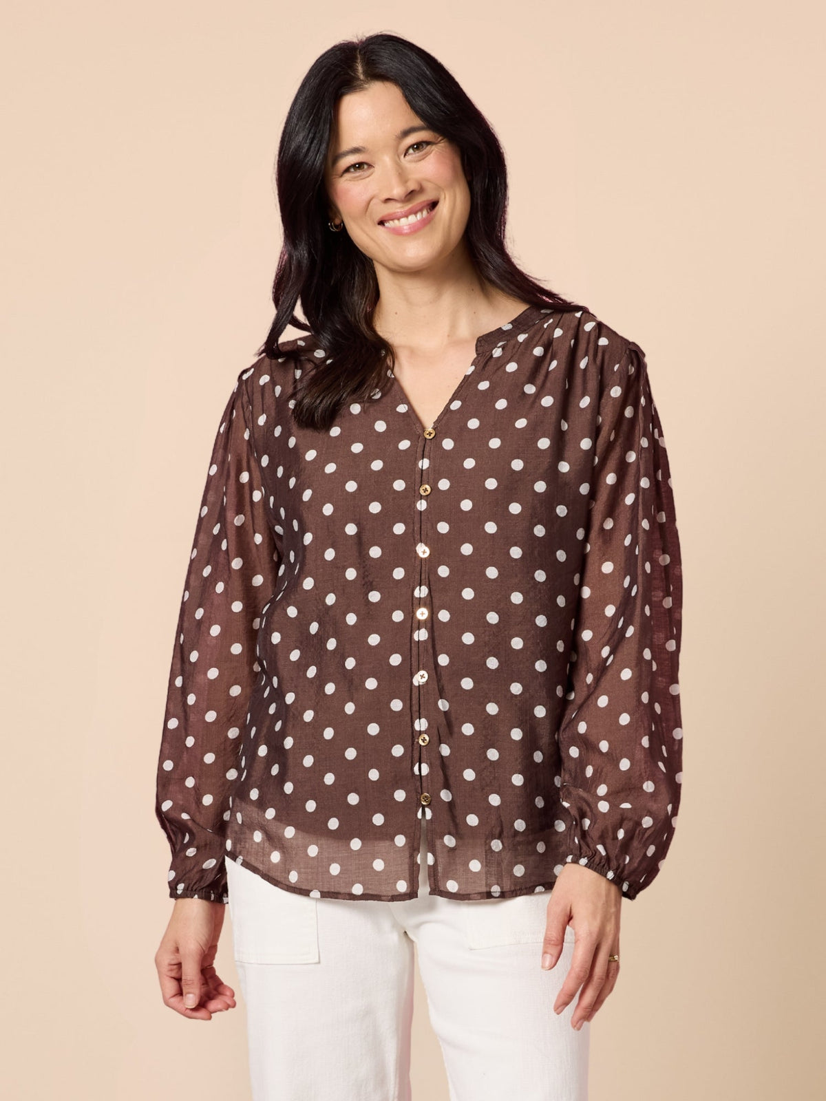 Image of a model wearing Tops. Product name - Aurora Spot Print Sheer Top Coffee White in Coffee White colour by brand - Gordon Smith