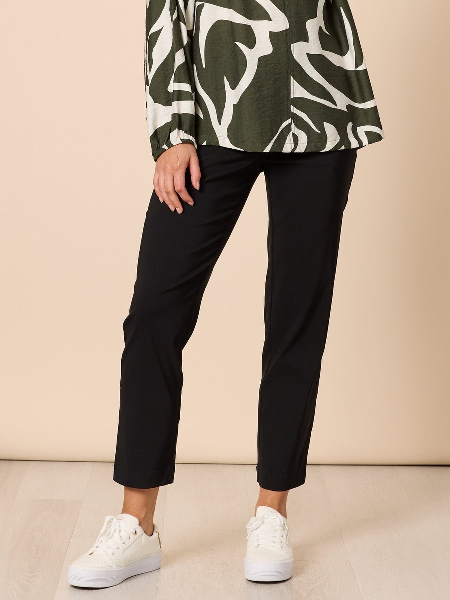 Image of a model wearing Pants. Product name - Evie Stretch Pant Black in Black colour by brand - Threadz