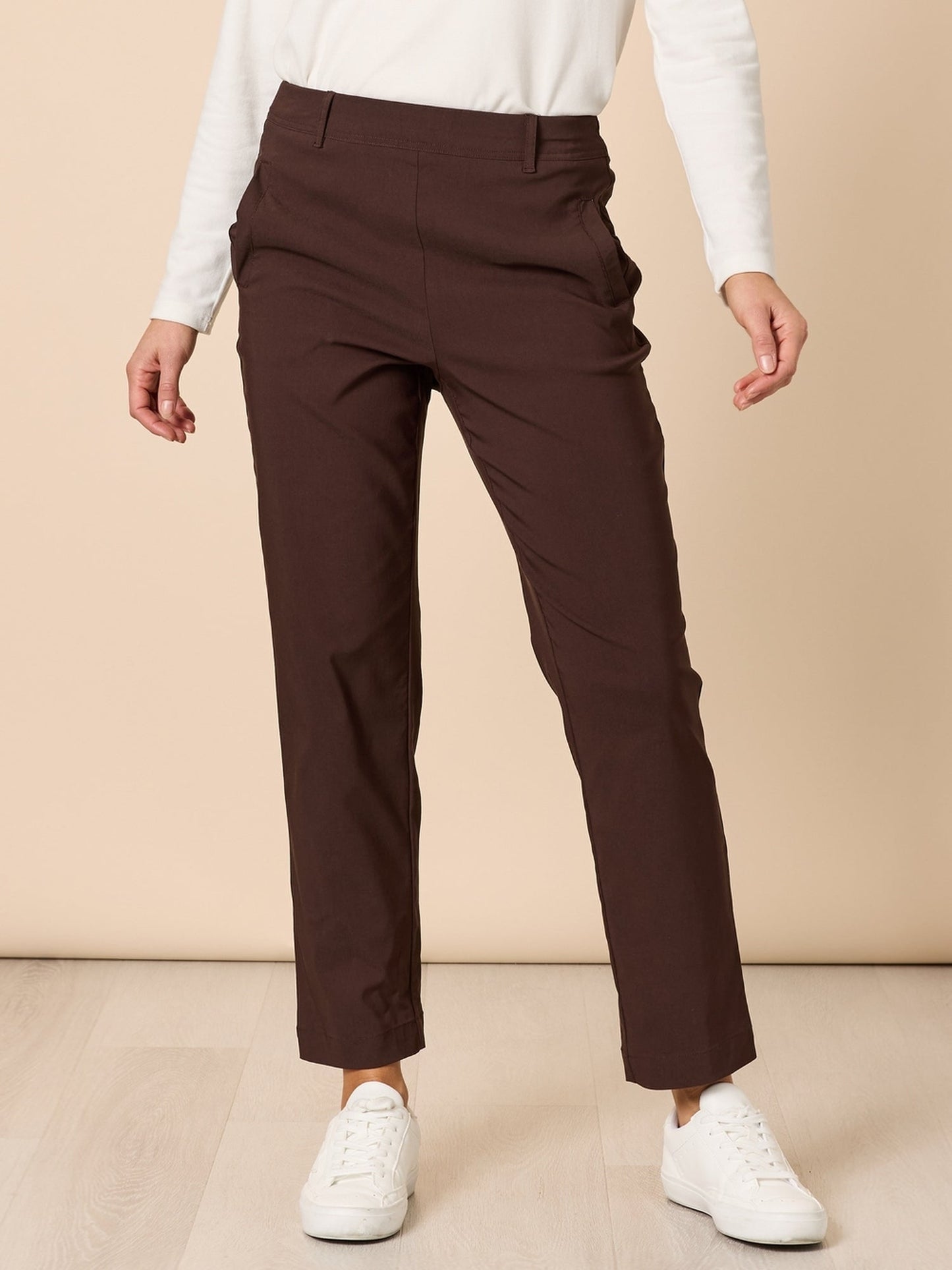 Image of a model wearing Pants. Product name - Evie Stretch Pant Coffee in Coffee colour by brand - Threadz