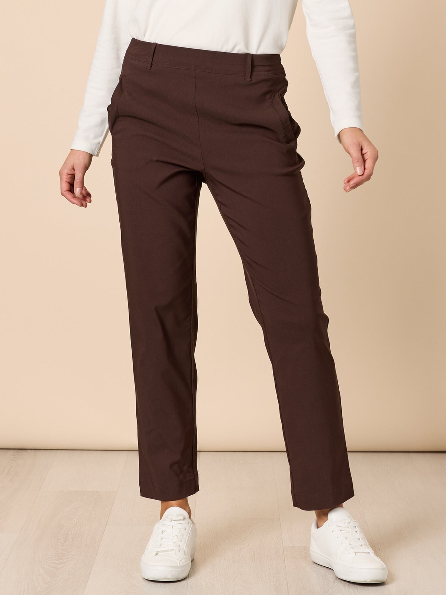 Image of a model wearing Pants. Product name - Evie Stretch Pant Coffee in Coffee colour by brand - Threadz