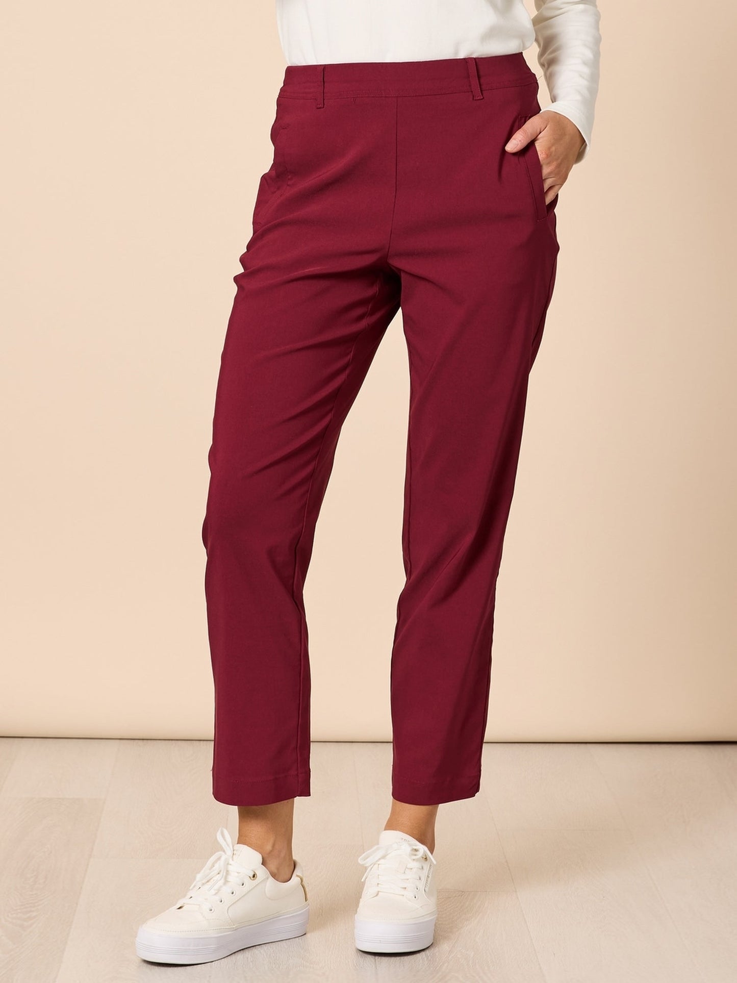 Image of a model wearing Pants. Product name - Evie Stretch Pant Shiraz in Shiraz colour by brand - Threadz