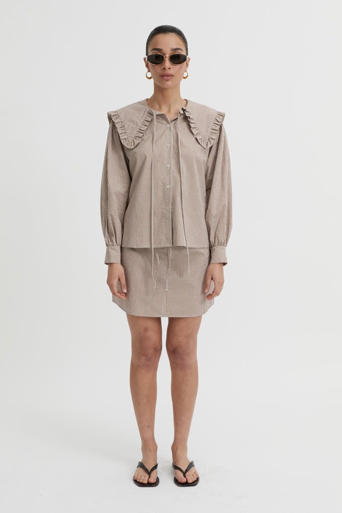 Image of a model wearing Skirts. Product name - Calypso Skirt Brown in Brown colour by brand - Blanca Studio