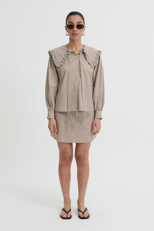 Image of a model wearing Skirts. Product name - Calypso Skirt Brown in Brown colour by brand - Blanca Studio