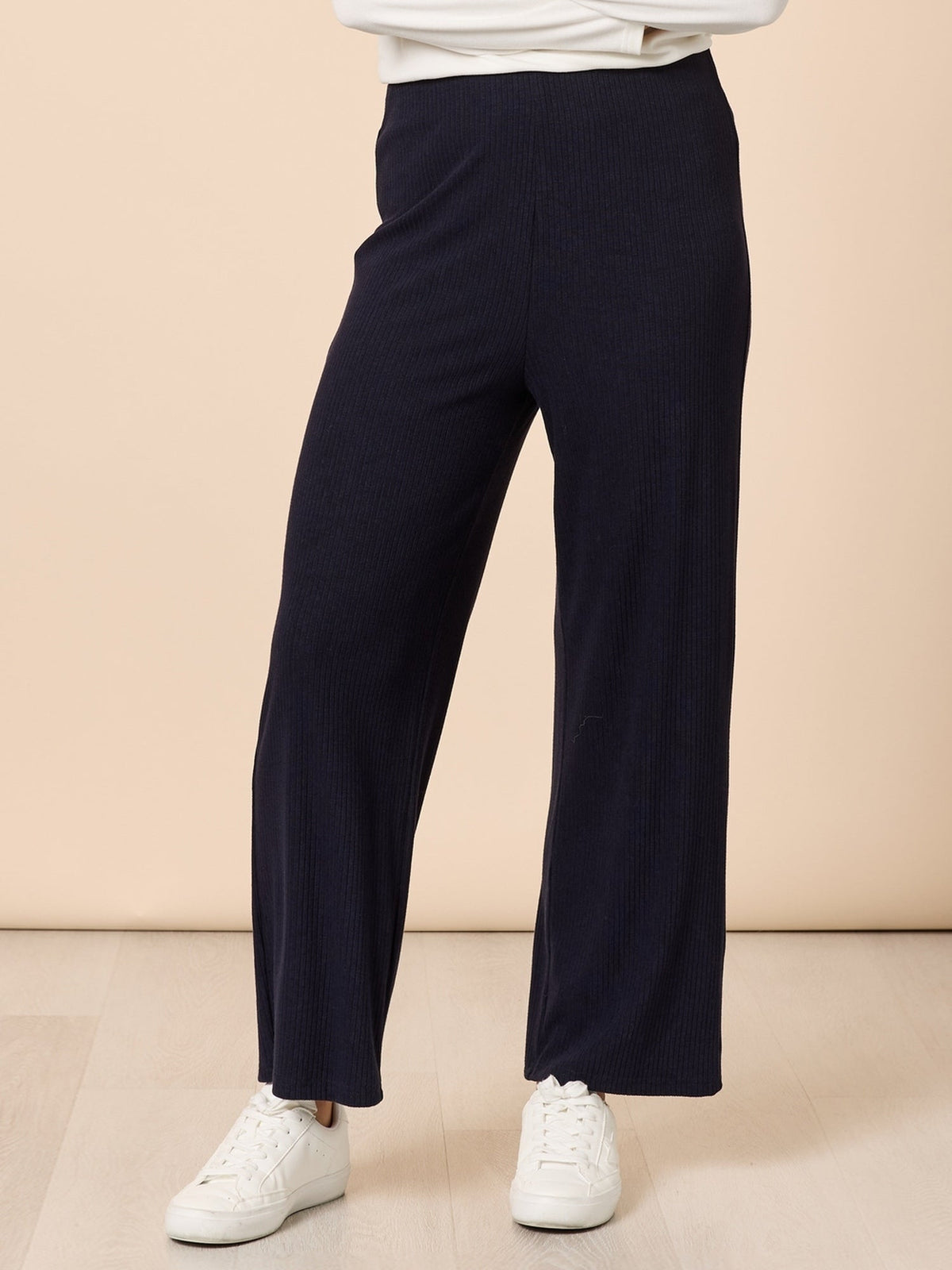 Image of a model wearing Pants. Product name - Le Lounge Pant Navy in Navy colour by brand - Clarity