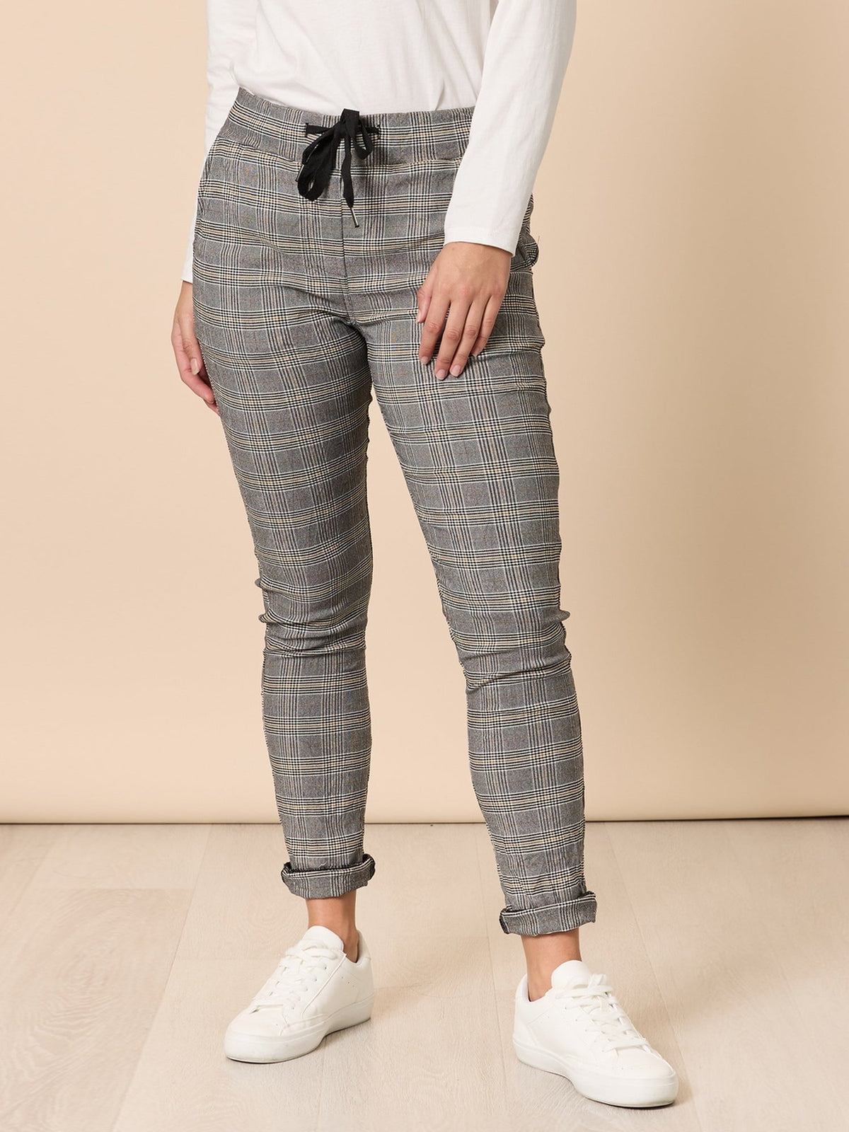 Image of a model wearing Pants. Product name - Chic Check Pant Natural in Natural colour by brand - Threadz