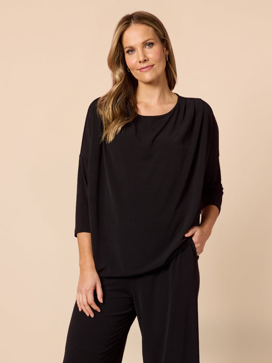Image of a model wearing Tops. Product name - Travellers Pleat Top Black in Black colour by brand - Clarity