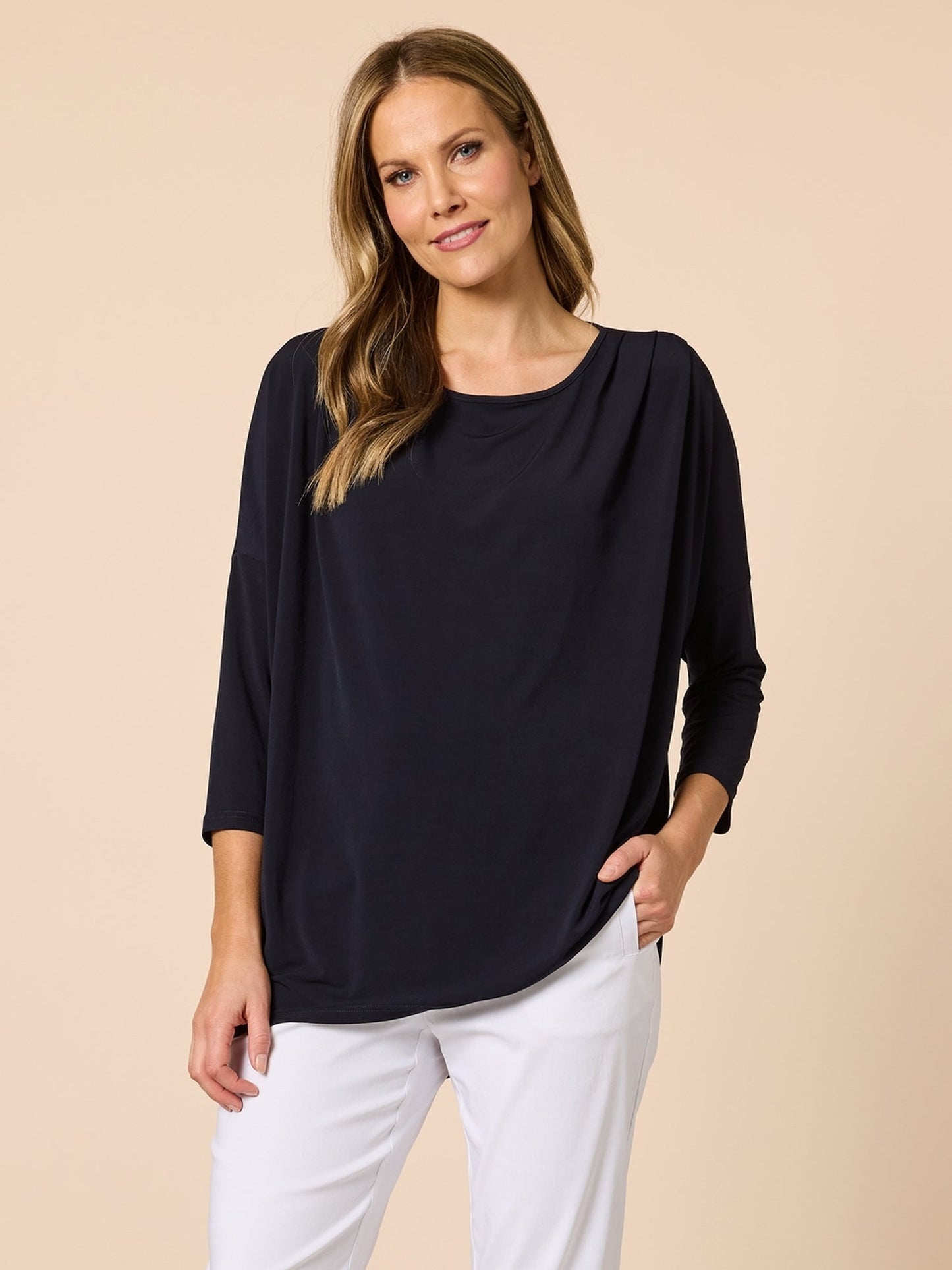 Image of a model wearing Tops. Product name - Travellers Pleat Top Navy in Navy colour by brand - Clarity