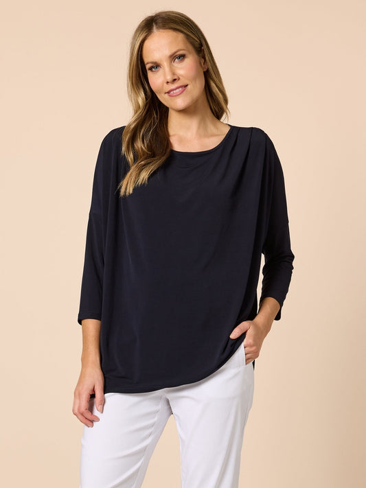 Image of a model wearing Tops. Product name - Travellers Pleat Top Navy in Navy colour by brand - Clarity