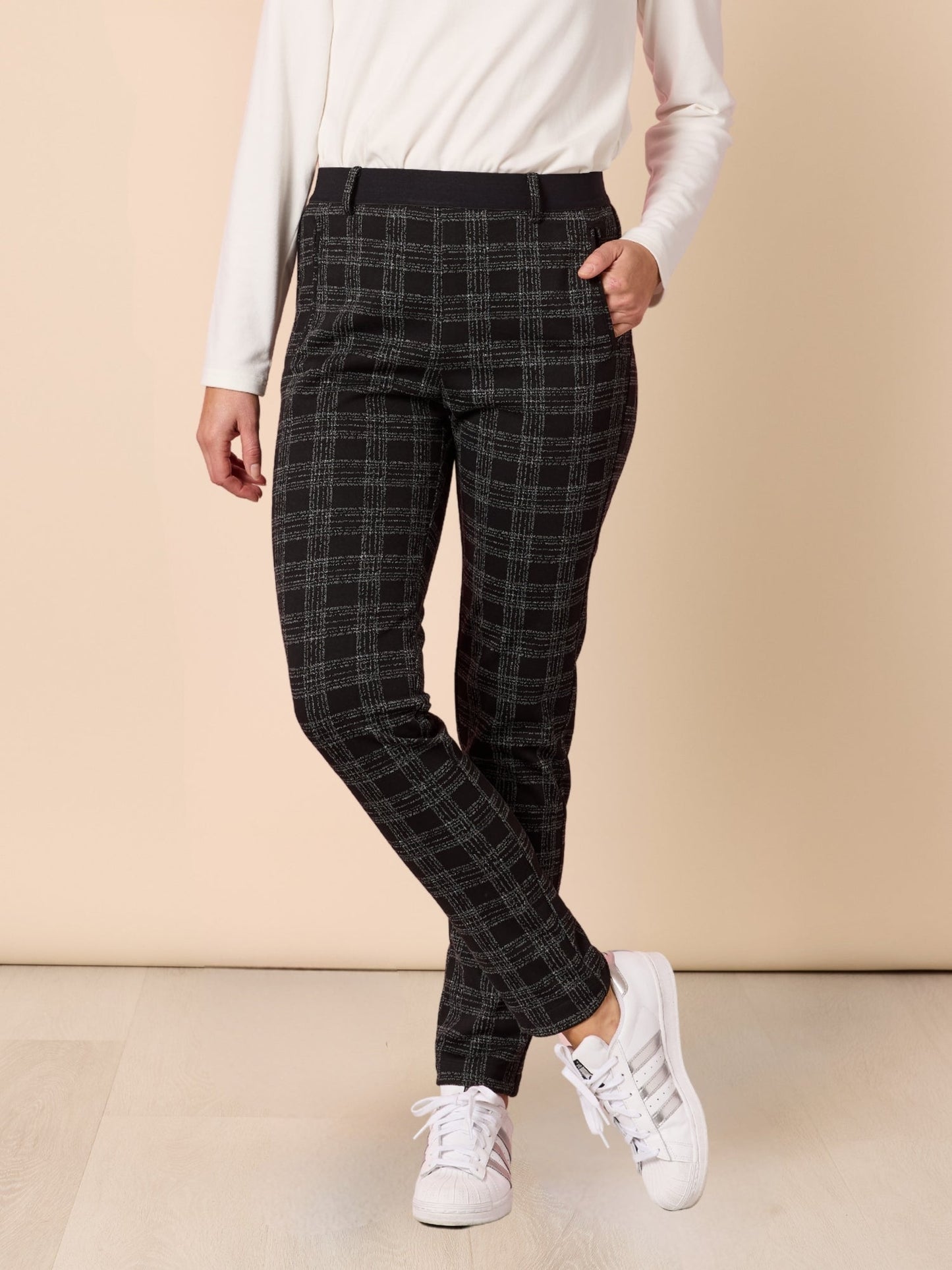 Image of a model wearing Pants. Product name - Cannes Check Pant Black in Black colour by brand - Clarity