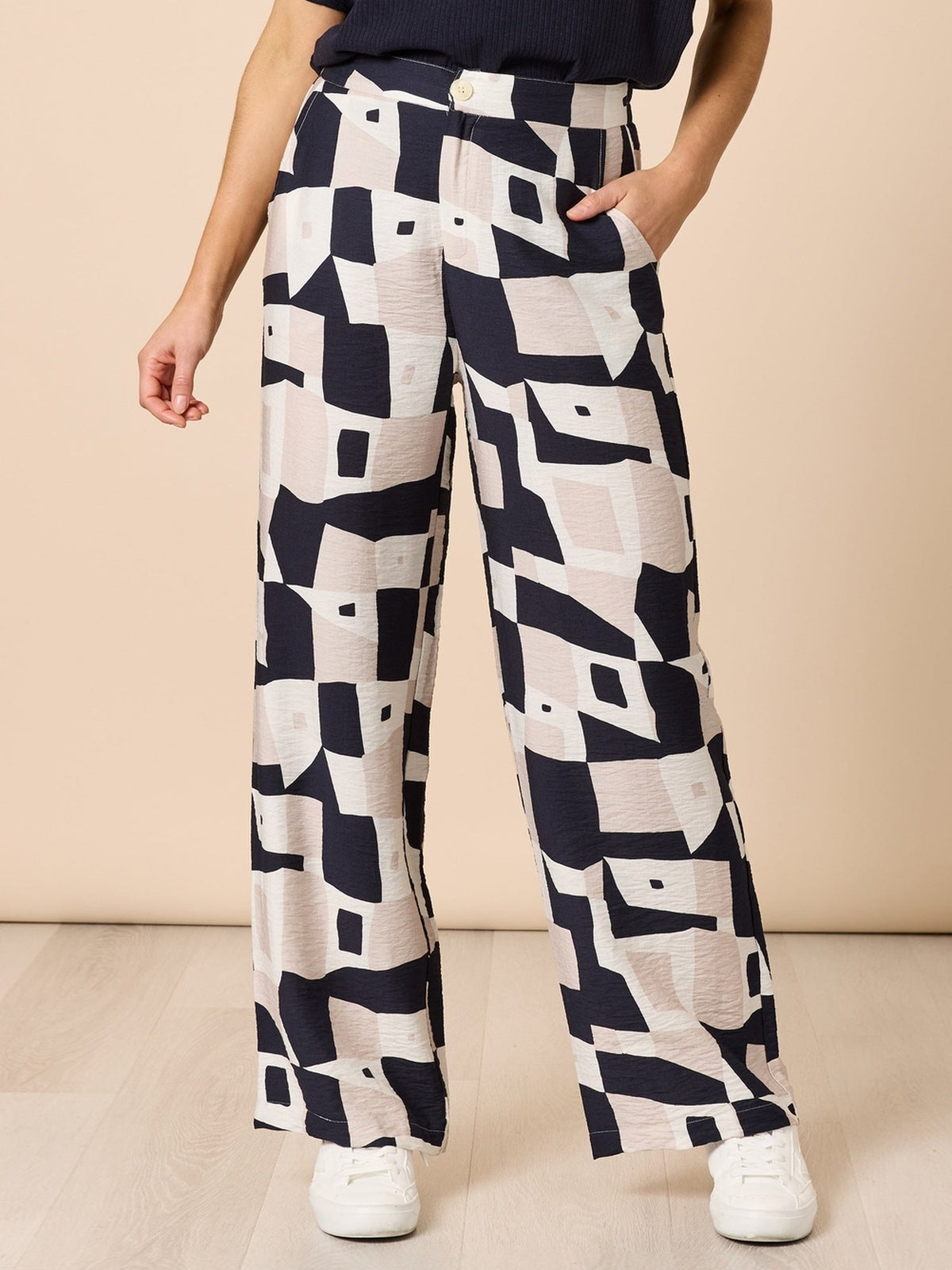 Image of a model wearing Pants. Product name - Rive Gauche Pant Navy Multi in Navy Multi colour by brand - Clarity